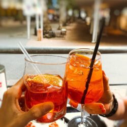 people clinking glasses of refreshing cocktails