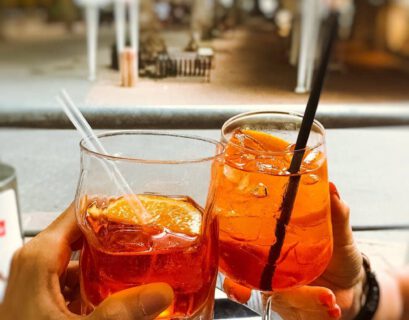 people clinking glasses of refreshing cocktails