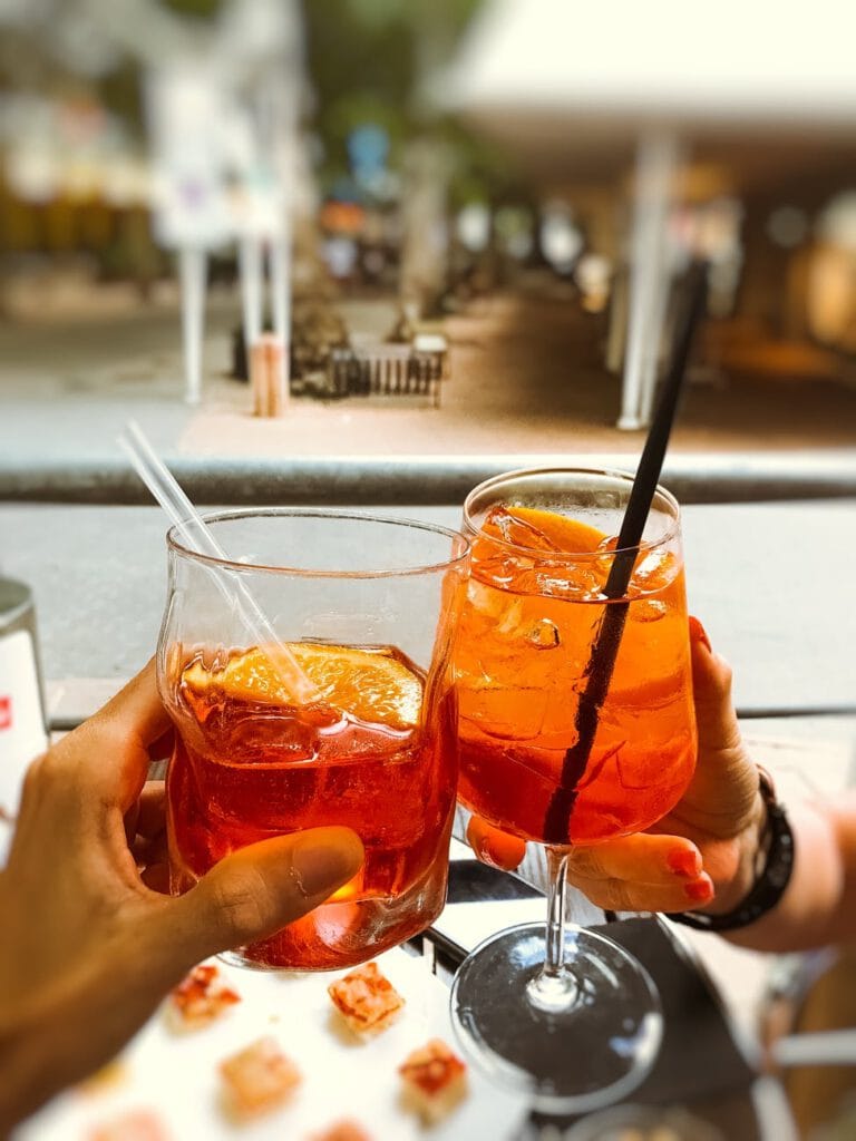 people clinking glasses of refreshing cocktails