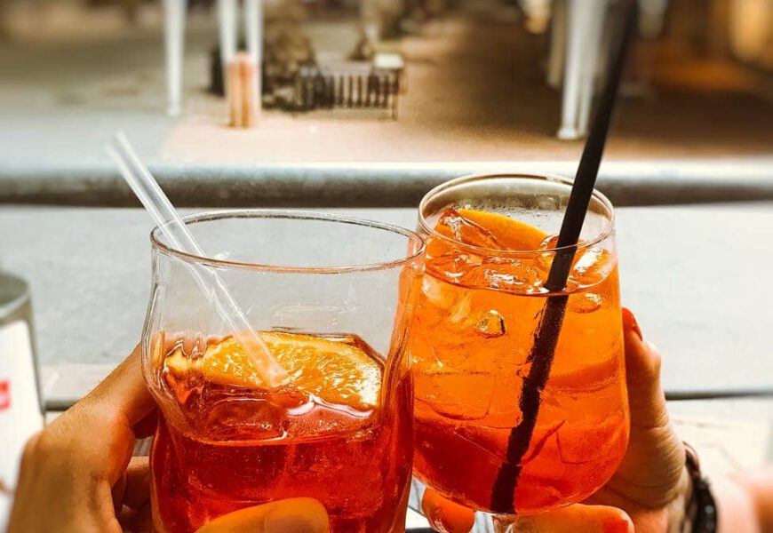 people clinking glasses of refreshing cocktails