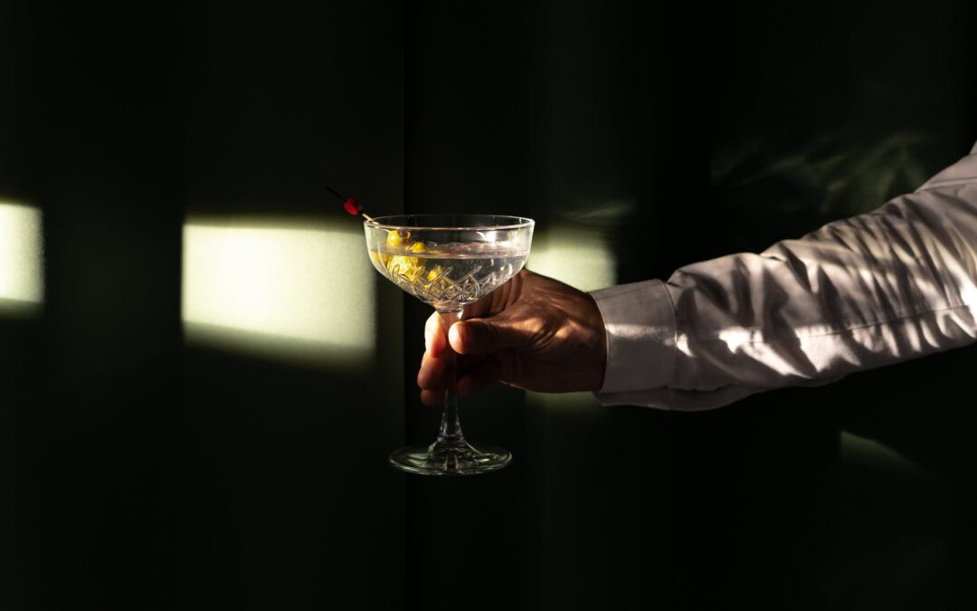 a person holding a martini cocktail