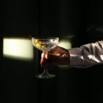 a person holding a martini cocktail