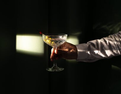 a person holding a martini cocktail