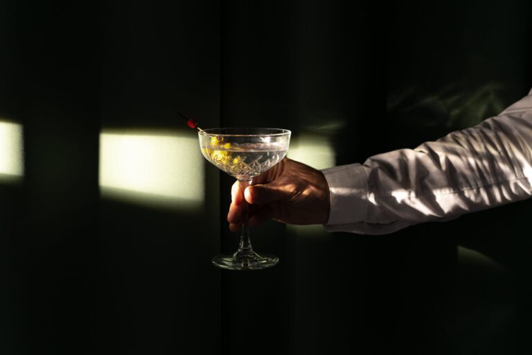 a person holding a martini cocktail