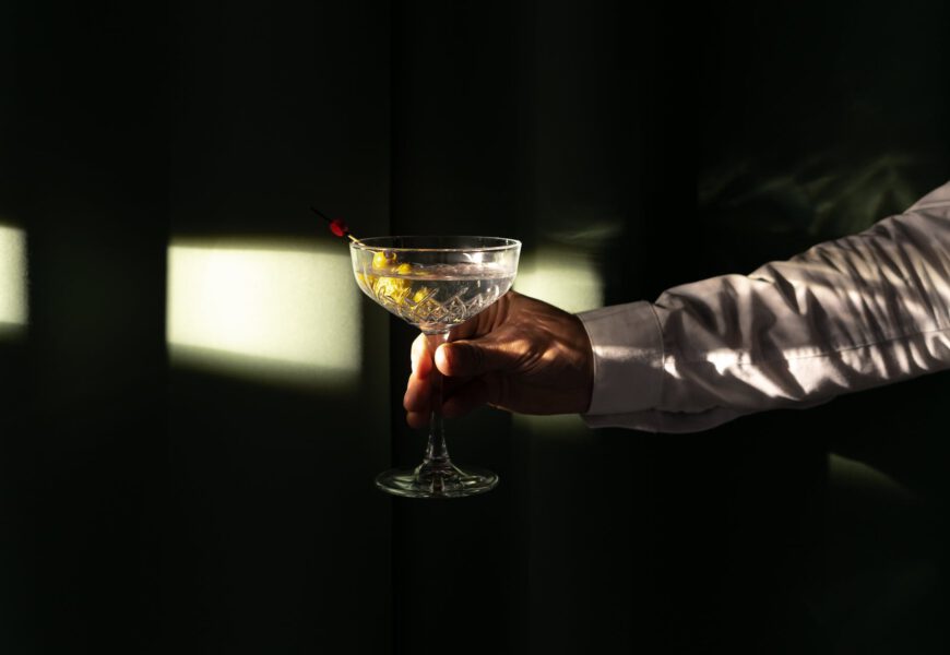 a person holding a martini cocktail