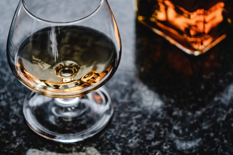 close up photo of brown liquor in a glass